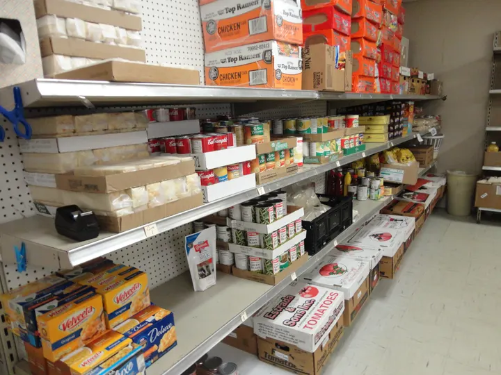Shelves of food at an Of One Accord pantry